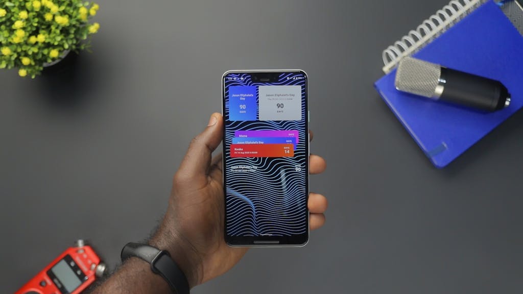 A Person Holding a Smartphone with a Heads-up Notification