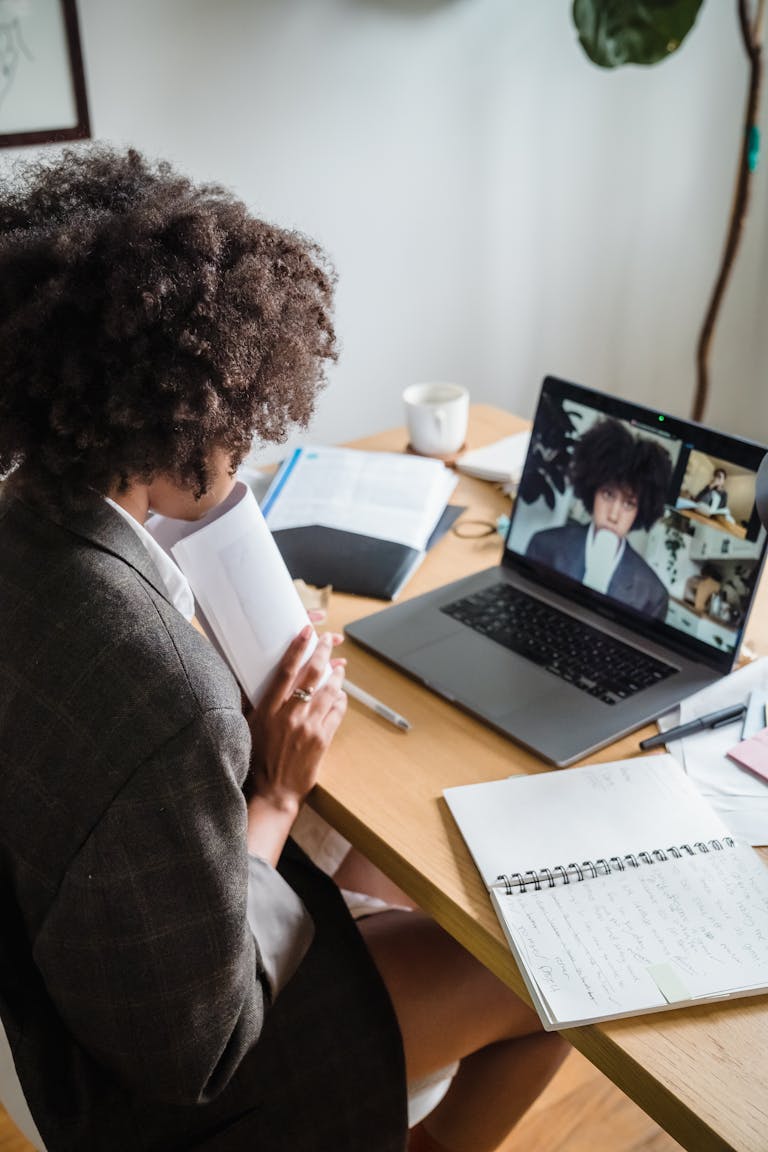 Woman Having an Online Meeting Sitting Behind a Desk in an Office