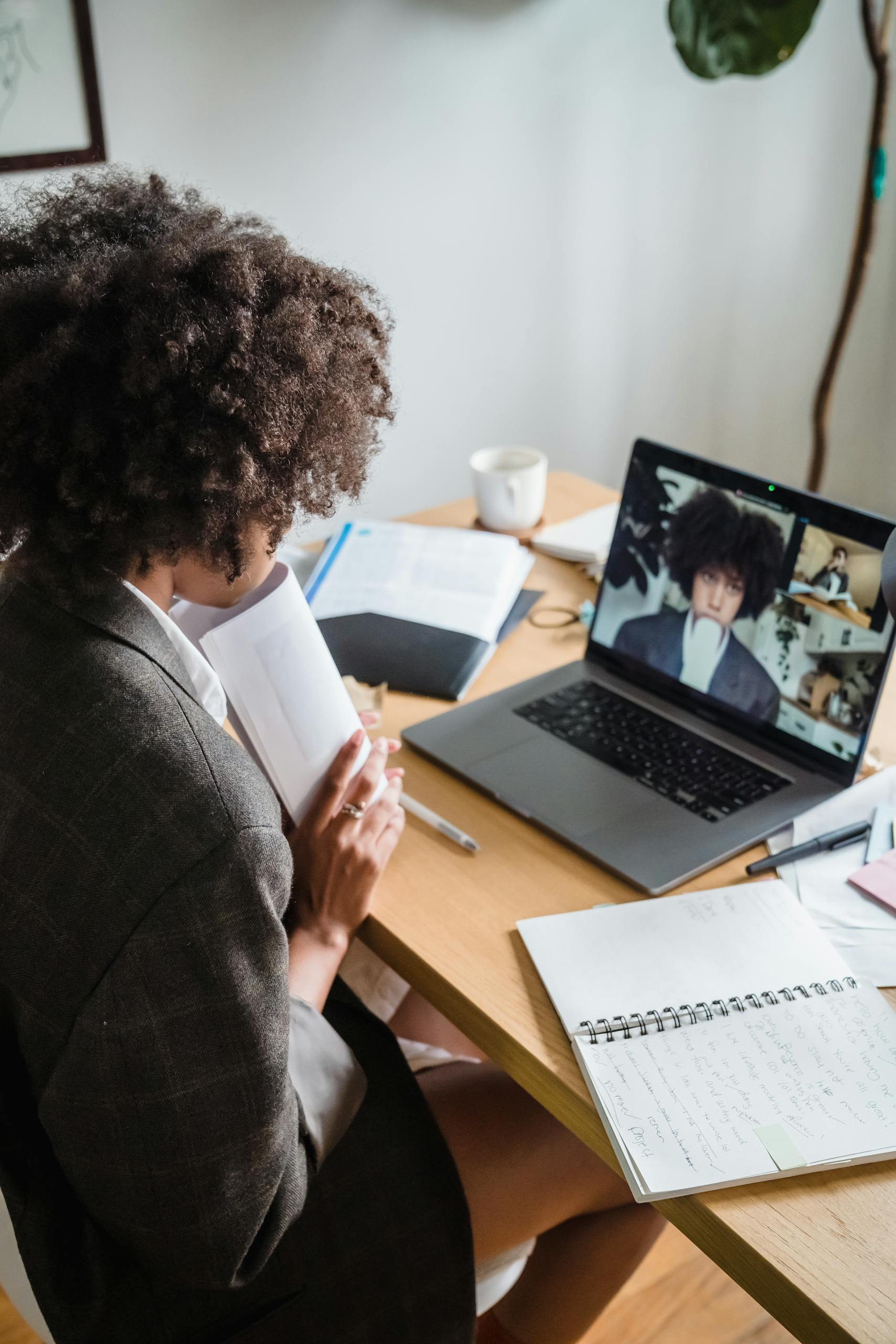 Woman Having an Online Meeting Sitting Behind a Desk in an Office