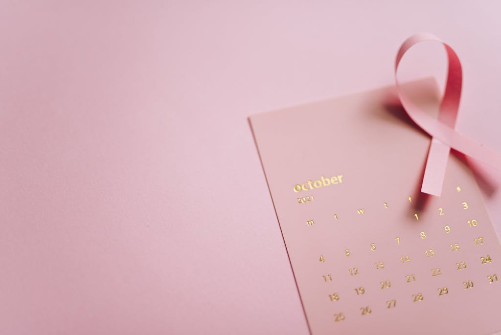 October breast cancer awareness with pink ribbon and calendar highlighting the fight against cancer.